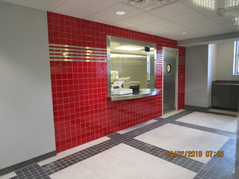 OPCC Snack Bar. Porcelain Floor tille over Schluter Ditra underlayment, and Ceramic Wall Tile with stainless steel accents